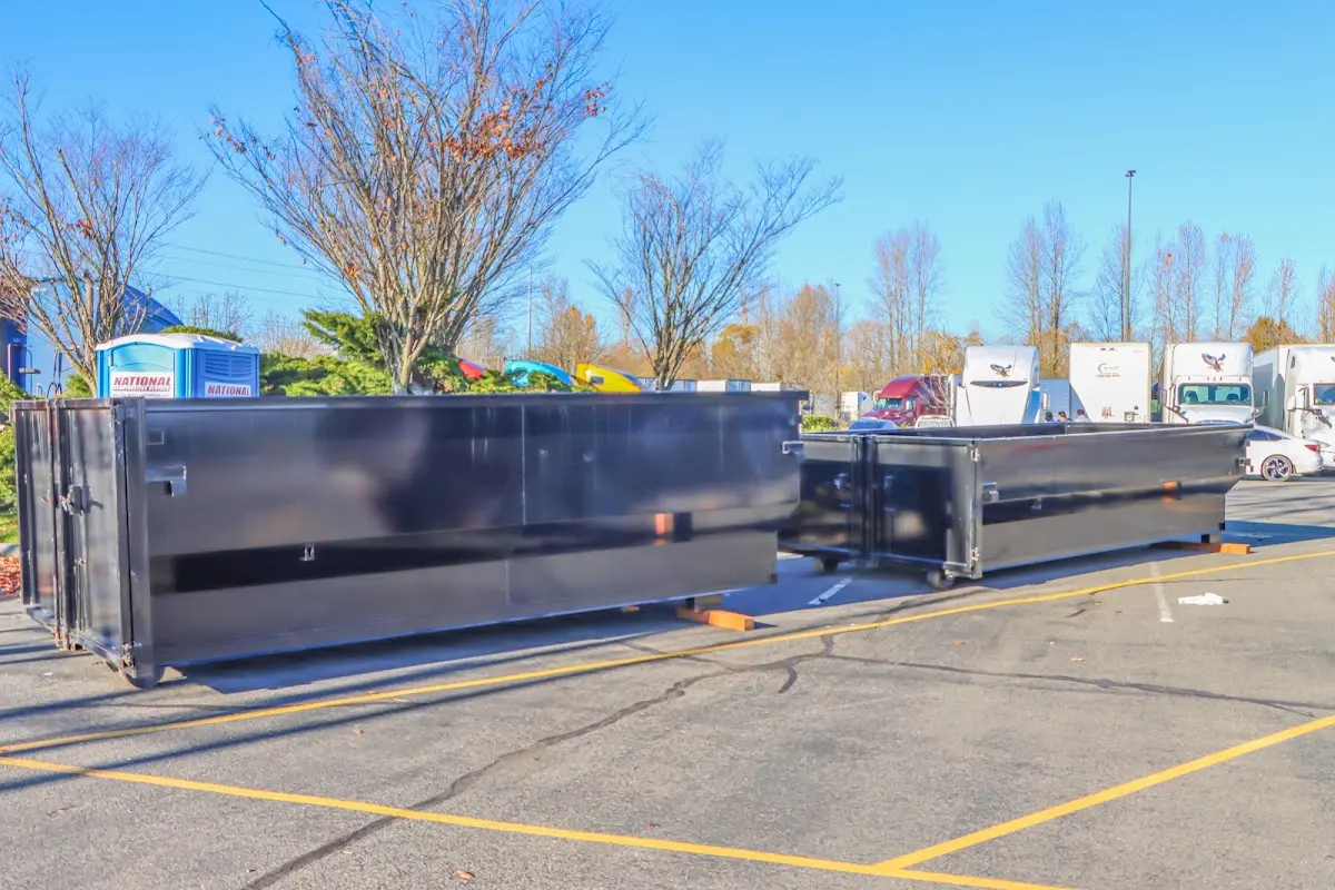 Professional dumpster rental service with roll-off container on residential driveway in New Hope